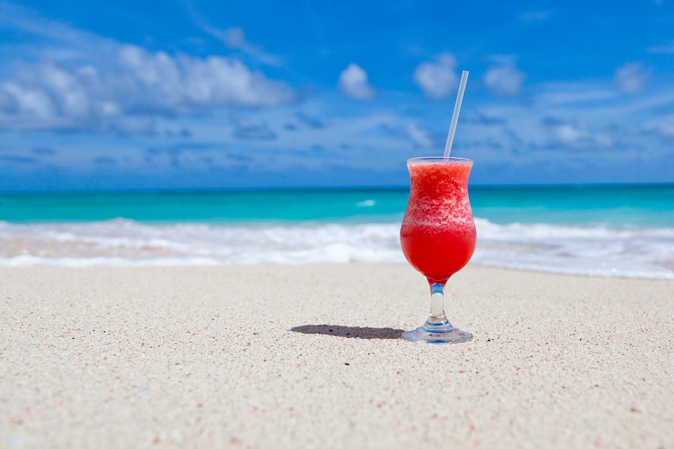 Summer Weight Loss. A fruity cocktail sitting on the beach.