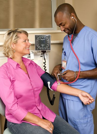 A woman having her blood pressure measured - weight loss can lower blood pressure